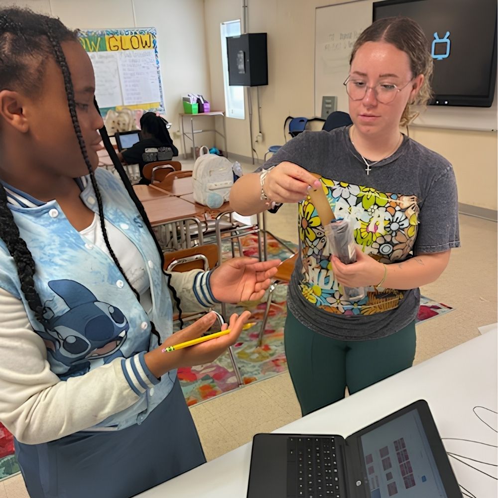 A student and camp staff member work on a hands-on STEAM project during Above and Beyond Students' free summer camp at Ranson Middle School in Charlotte, NC.