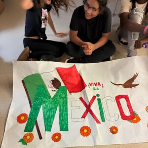 Students display their hand-colored Team Mexico banner during Above and Beyond Students' free summer camp Olympics at Ranson Middle School in Charlotte, NC.