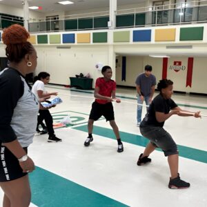 Students play tug of war in the gym during Above and Beyond Students' free summer camp Olympics at Ranson Middle School in Charlotte, NC.